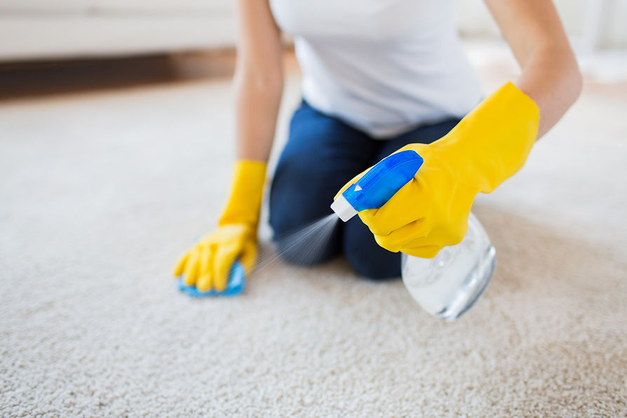 people, housework and housekeeping concept - close up of woman in rubber gloves with cloth