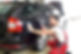 A person polishing a black car with a cloth