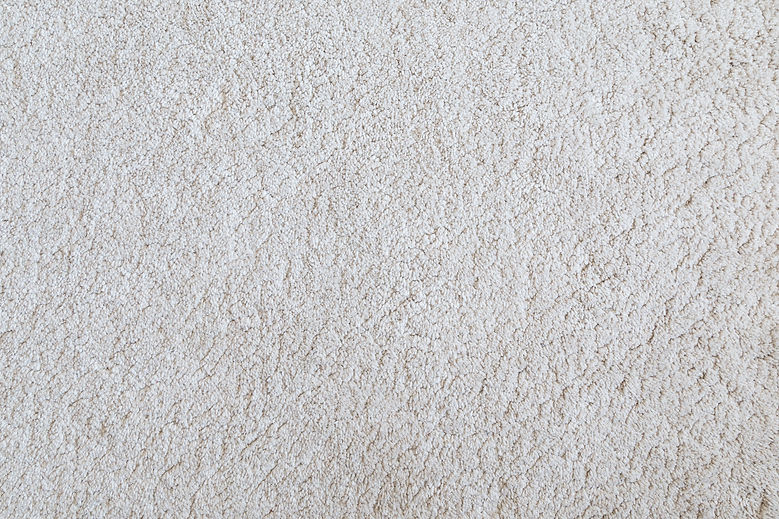 White shaggy carpet texture background viewed from above
