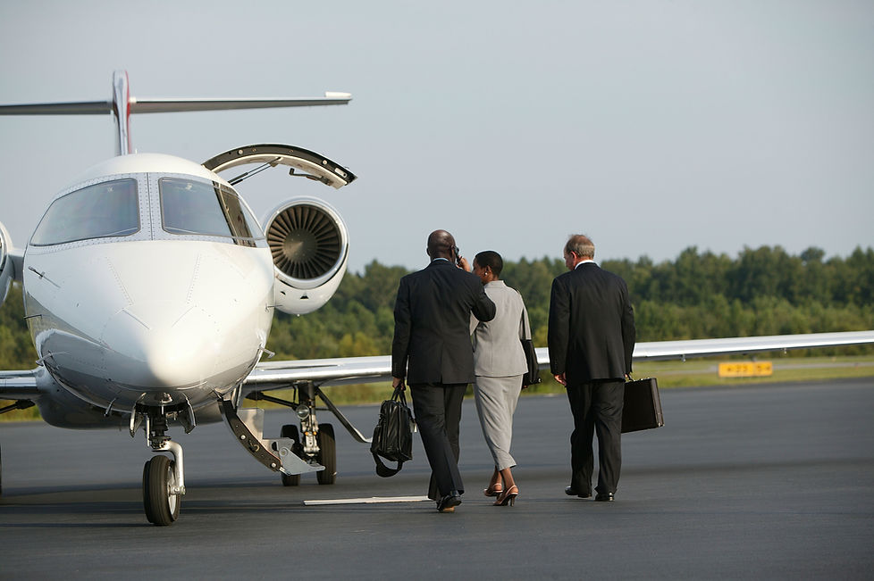 Close protection team walking towards a private jet on an airport runway tarmac