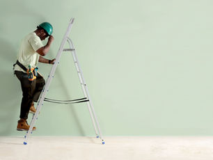 Technician in a hard hat climbs a ladder to check a wall — preventive maintenance list