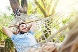Man Relaxing in Hammock