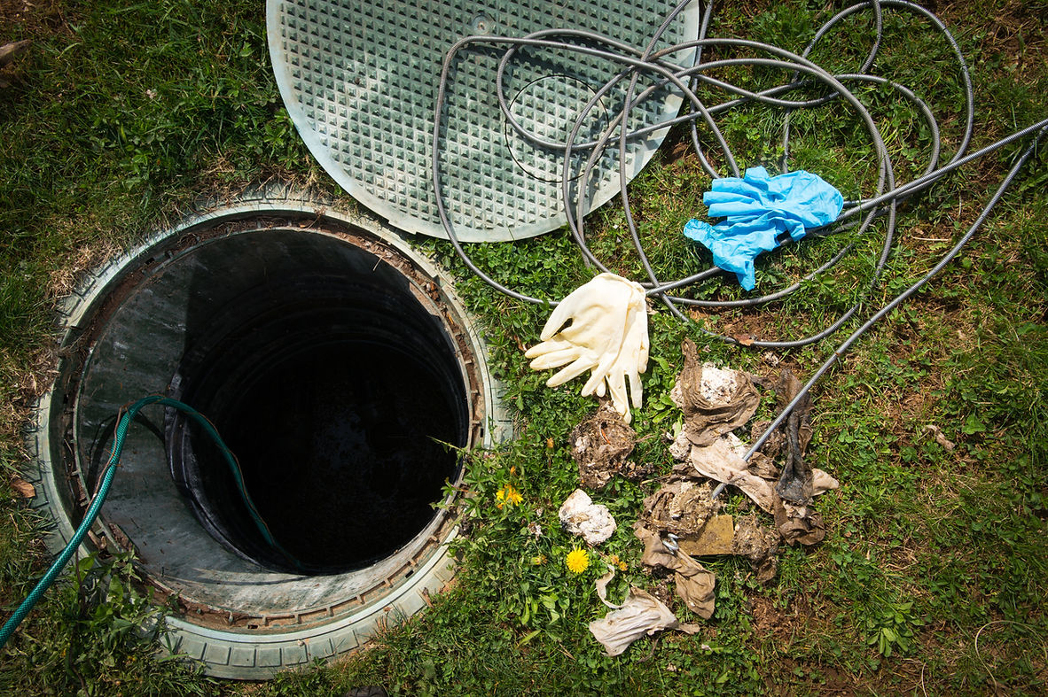 Unclogging septic system. Cleaning and unblocking drain full of disposable wipes and other