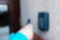 Woman opening house doors with electronic remote transmitter