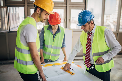 Construction workers and architects working on construction site
