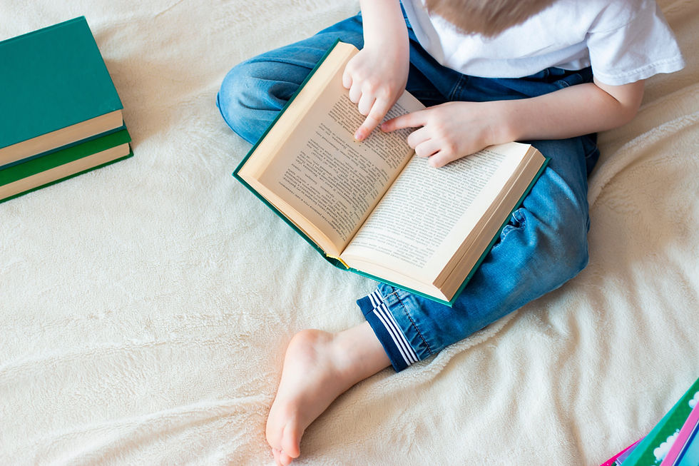 Child Reading Book in a private speech therapy session