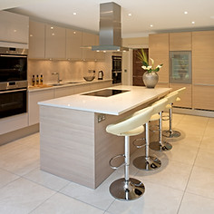 Modern, sleek kitchen with beige cabinets and stainless steel appliances