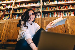 Smiling Student Studying in Library