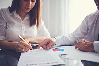 Professional team collaborating on document review with a colored chart on the desk