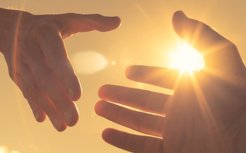 Hands Reaching in Sunlight