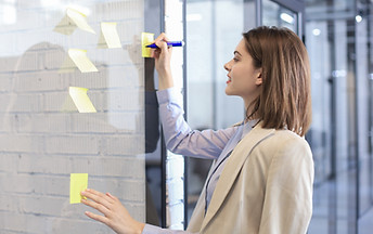 Writing on yellow post-it notes