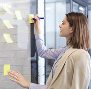 Writing on yellow post-it notes