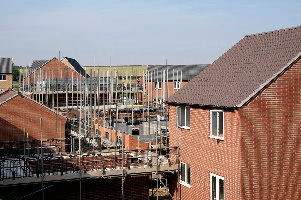 Rooftop view of suburban homes under a blue sky