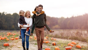 A family walking in a pumpkin patch