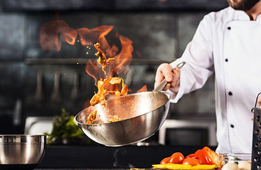 Chef cooking over a hot flame