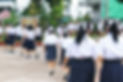 male and female students walking into school