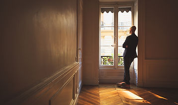Man Looking Out the Window