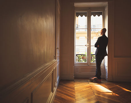 Man Looking Out the Window