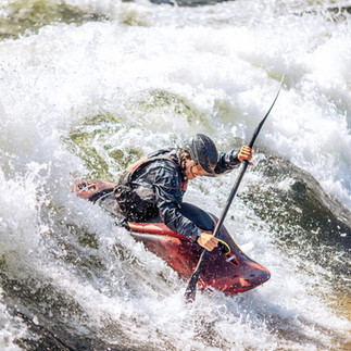 Canoeing in rapid waters.