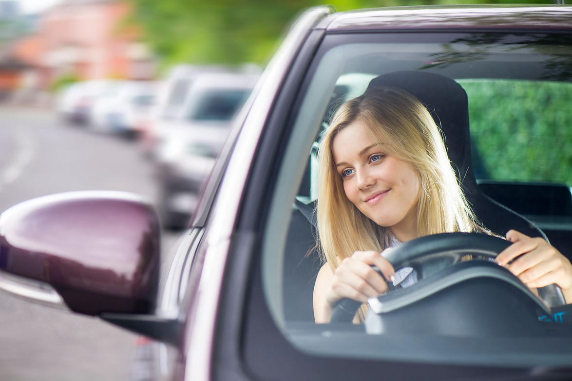 Young woman driving confidently