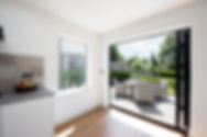 View of kitchen with bifold doors leading out to garden