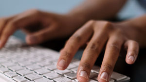 Someone typing on a keyboard