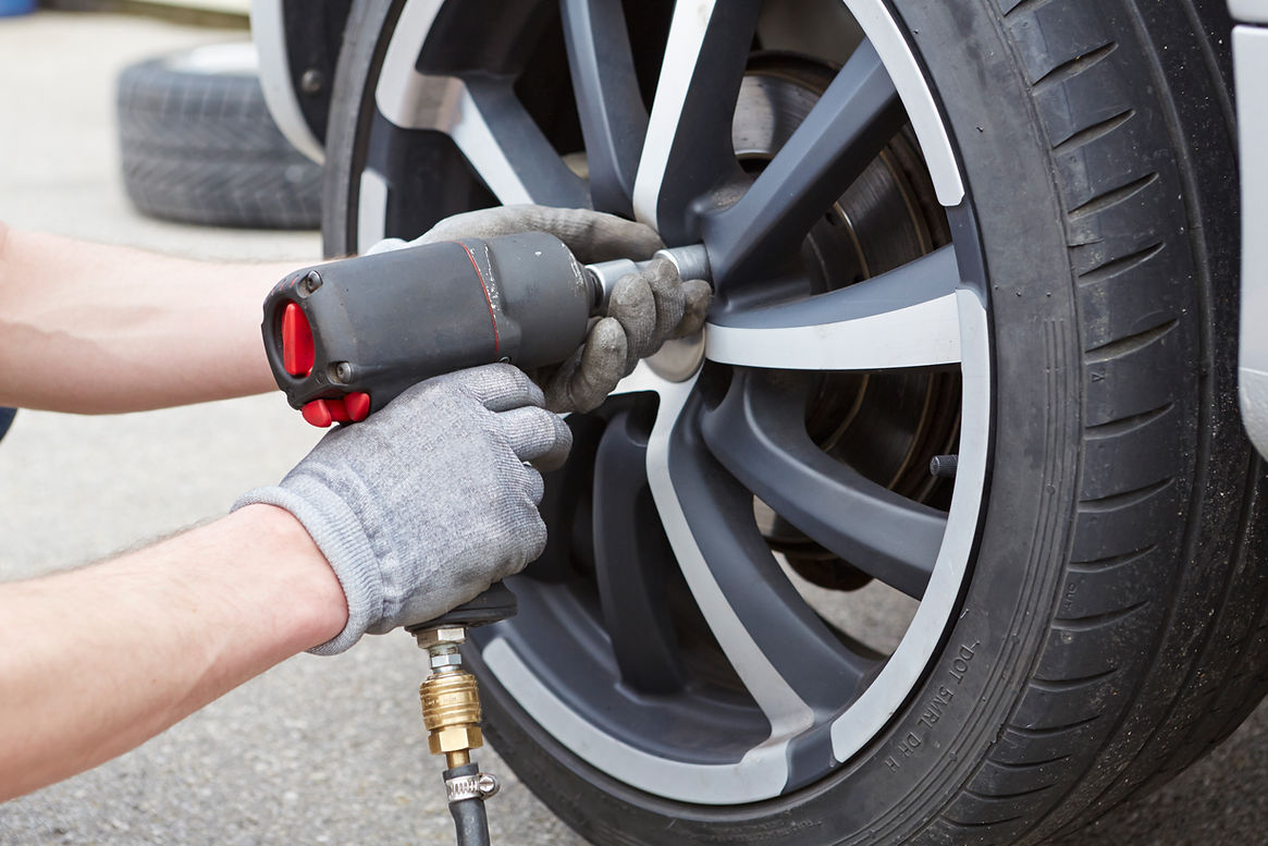 Mature man changing car tire