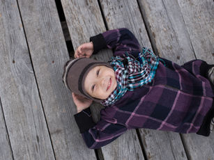 Happy child resting outdoors—joy-centered leadership and protecting team energy to prevent burnout.