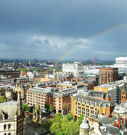 Idyllic view of rainbow over cityscape against cloudy sky seen from Chancery Place