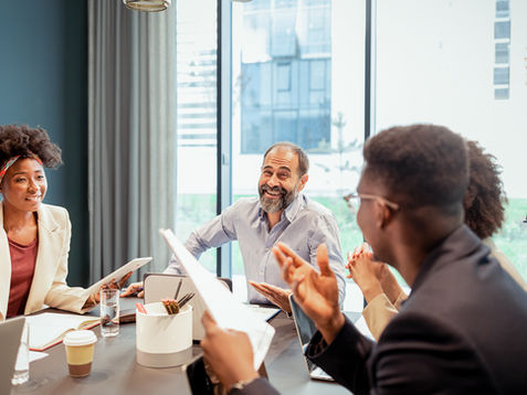 Professional team presenting business strategy ideas to senior executives in a corporate meeting room