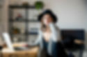Young woman sitting at a laptop in a home office