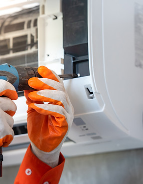 Hands Repairing Air Conditioner