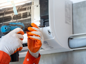 Hands Repairing Air Conditioner