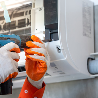 Hands Repairing Air Conditioner