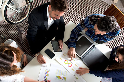 Business team reviewing financial charts and documents around a table