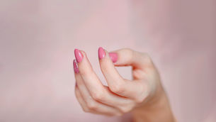 Open hand with palm facing up against a blurred beige background, conveying effective hand joint flexibility exercises