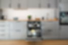 Integrated dishwasher with the door open in a contemporary grey kitchen
