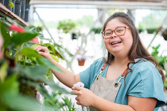 girl with down syndrome cutting plants