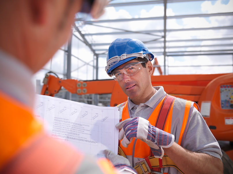 Construction workers reading blueprints