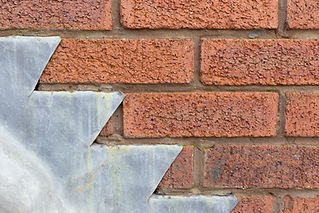 House building roof tiles lead join against brick wall