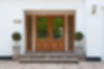 front view of an entrance of a house with wooden gate installed