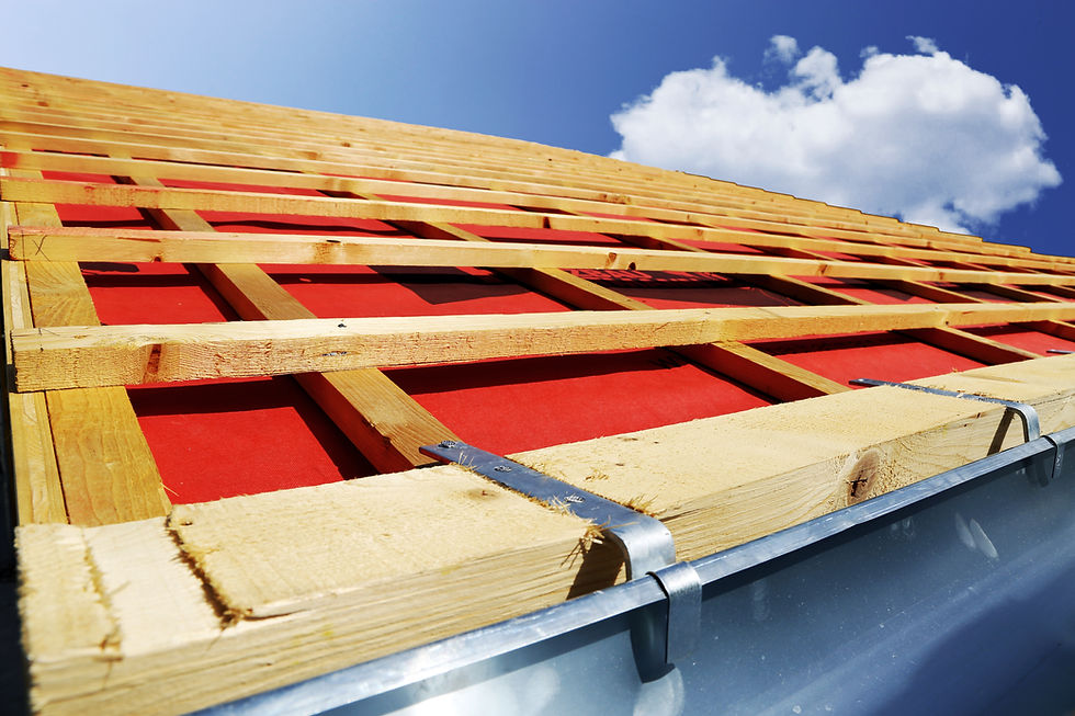 Roof framing under construction showing exposed wooden rafters and battens