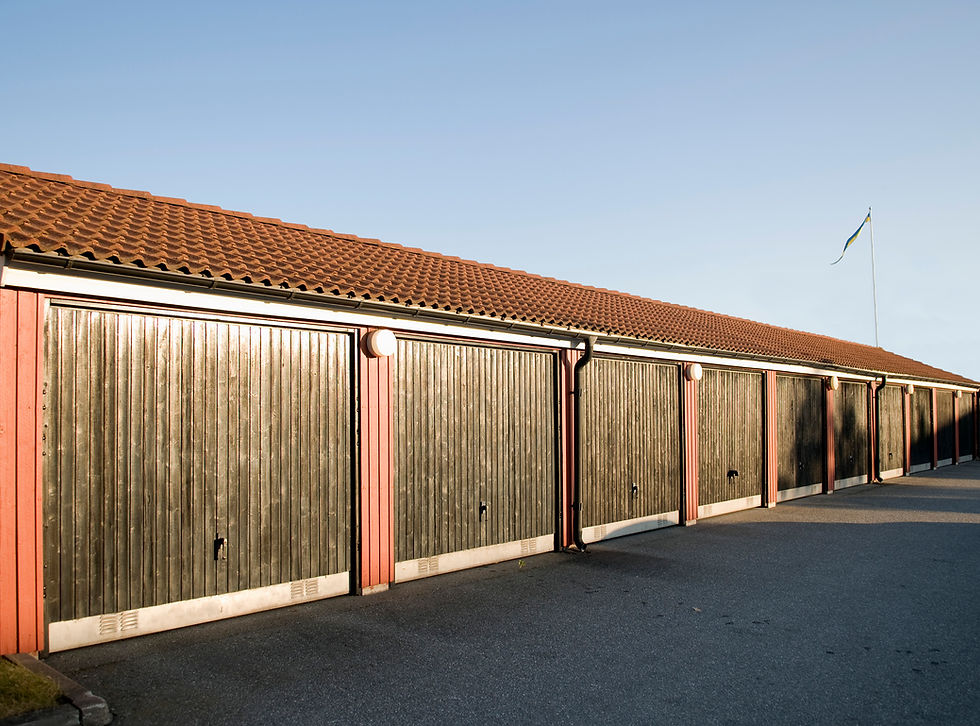 Wooden perimeter fence bordering a blacktop driveway