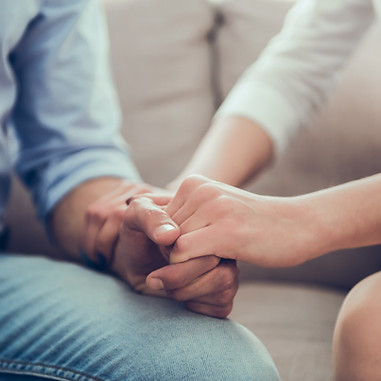 couple holding hands symbolizing connection and healing in trauma therapy