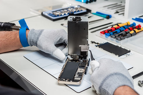 Technician replacing the screen of a used smartphone