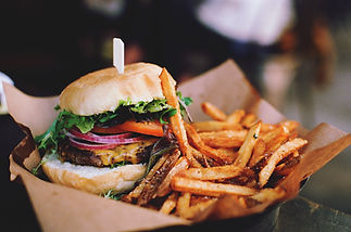 Close-Up image of Burger With French Fries On Table