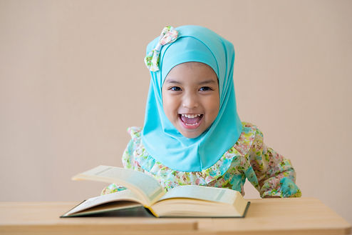 A muslim girl reading a book