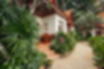 A walking path in front of a bungalow