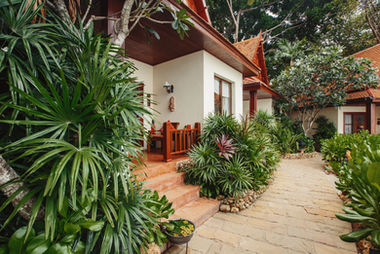 A walking path in front of a bungalow