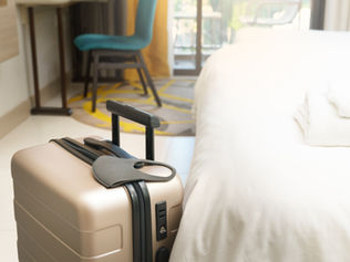 suitcase by bed